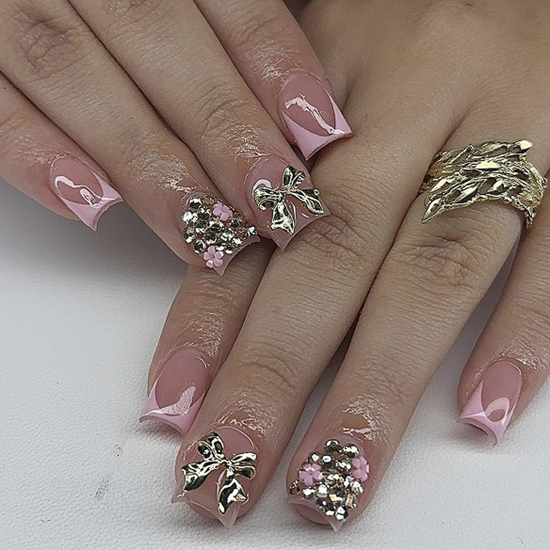 Artful nail art with glitter accents and bow decoration Bowlift