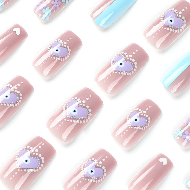 Artful nail art with floral accents and glitter embellishments Bowlift