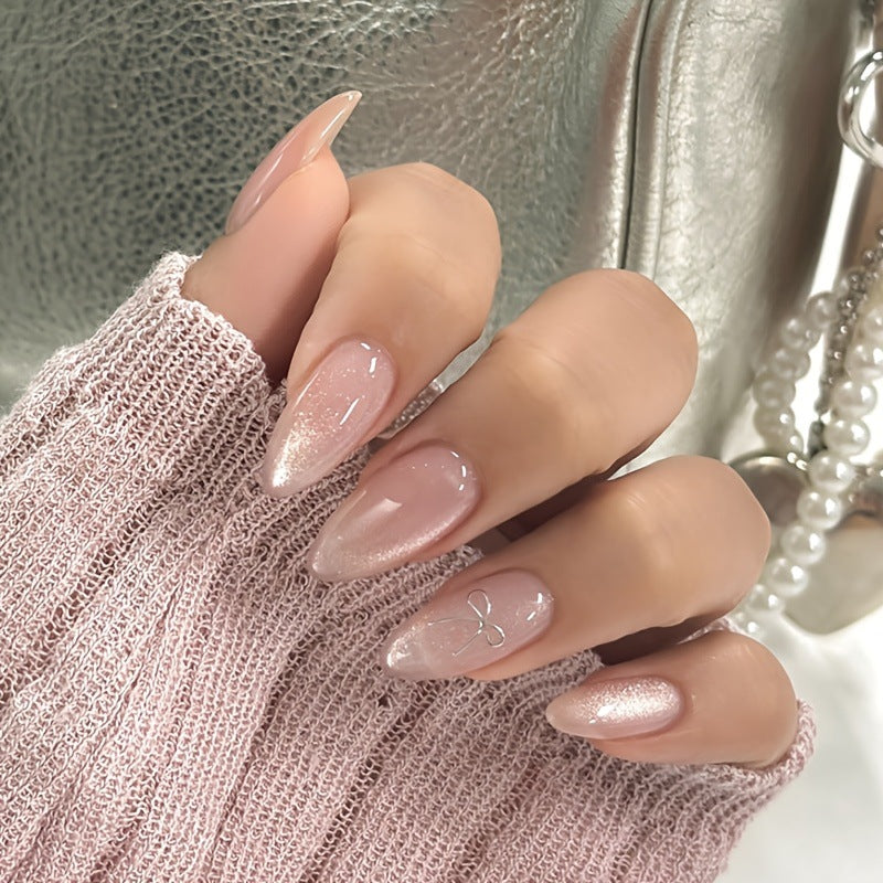 Artificial nail set with delicate glitter and elegant bow decorations Bowlift