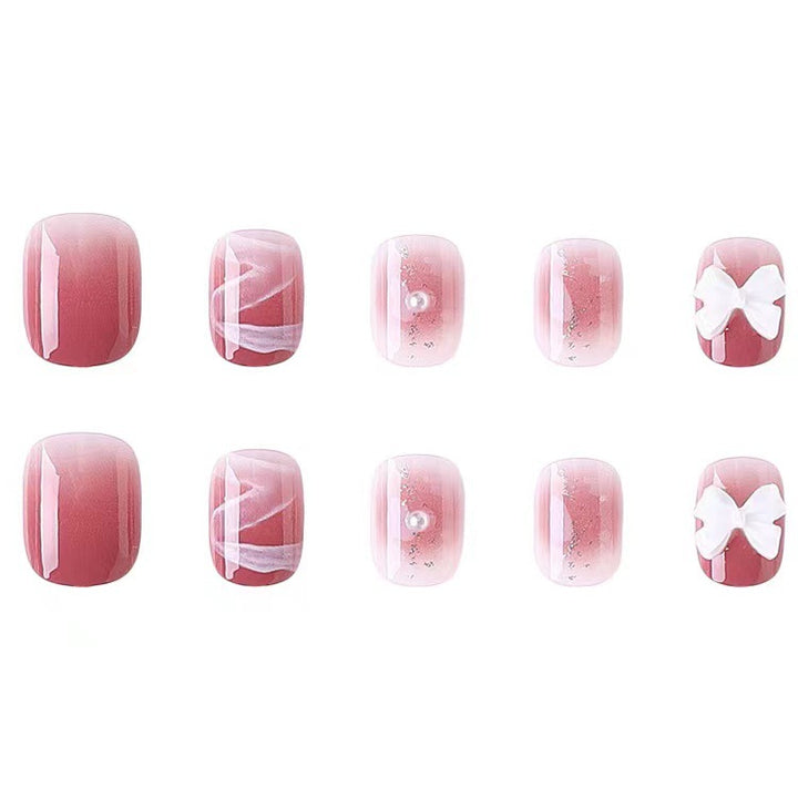 Glamorous nail art with pearl and bow accents Bowlift