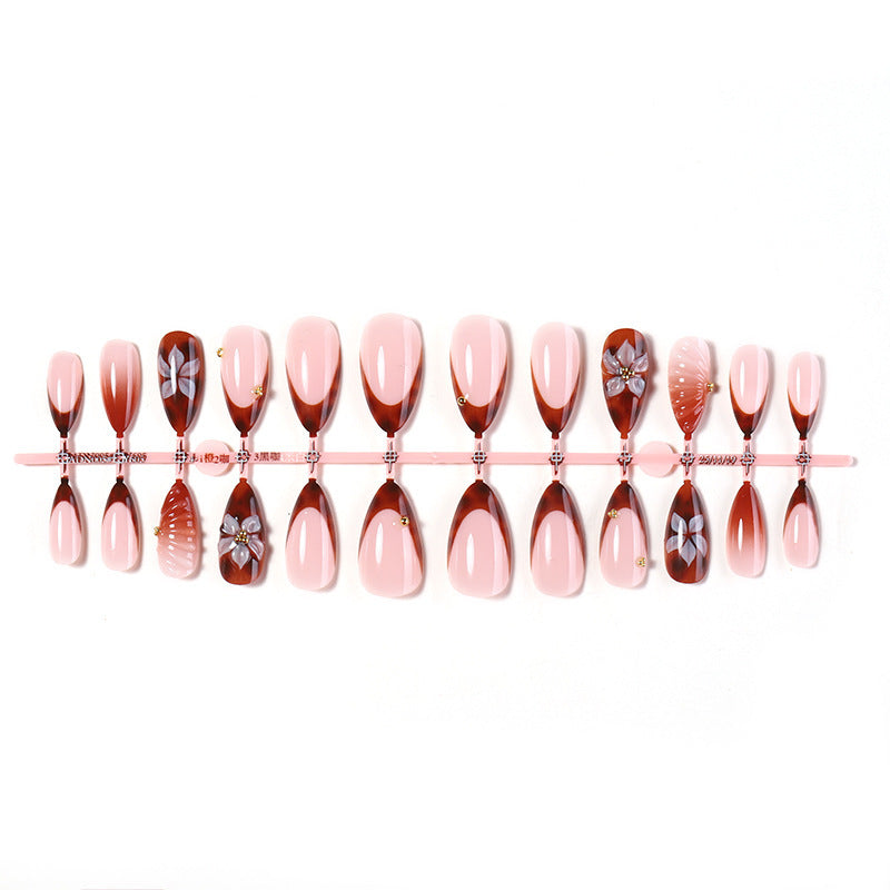 Nail art set with detailed ombre design and creative flower accents Bowlift