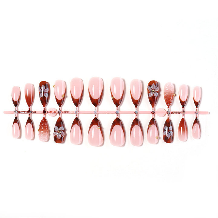 Nail art set with detailed ombre design and creative flower accents Bowlift