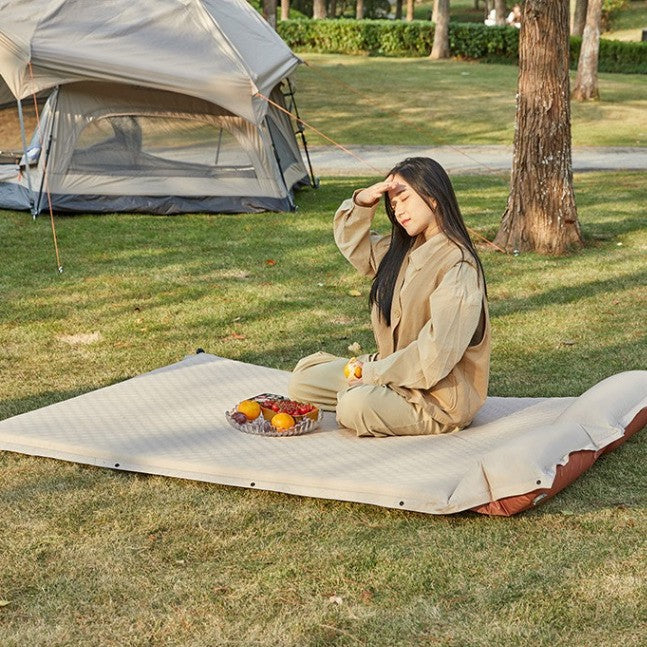 outdoor foldable camping and picnic mat with inflatable cushioned edge and waterproof base Bowlift
