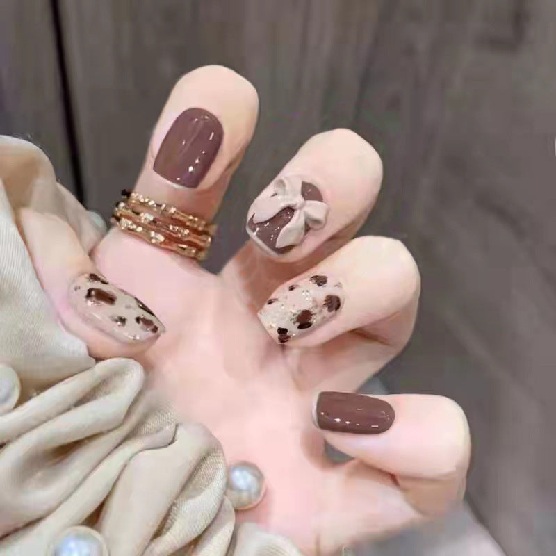 Glamorous artificial nails with heart design and glittering accents Bowlift