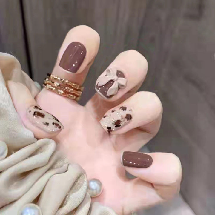 Glamorous artificial nails with heart design and glittering accents Bowlift