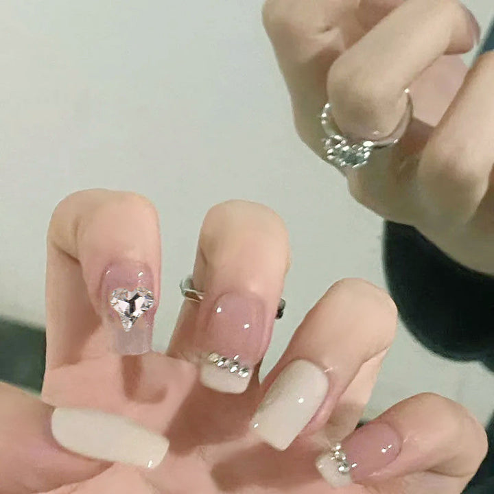 Glamorous artificial nails with heart and rhinestone decorations Bowlift