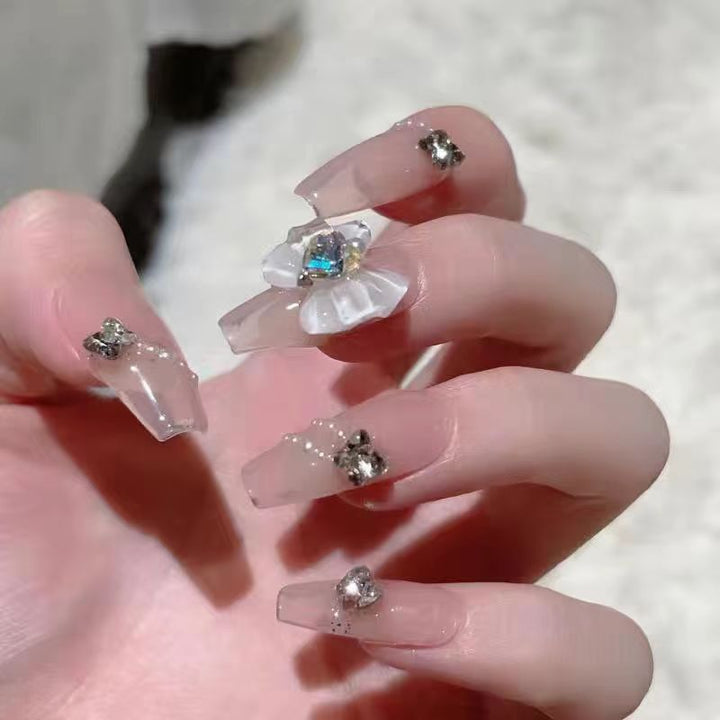 Artistic Nail Art with Glitter and Flower Applications Bowlift