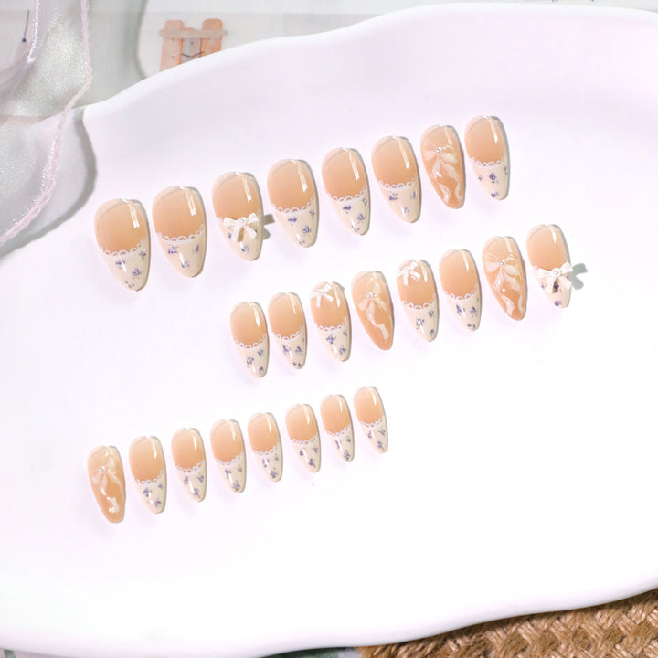 Artful nail art with elegant bows and rhinestone details Bowlift