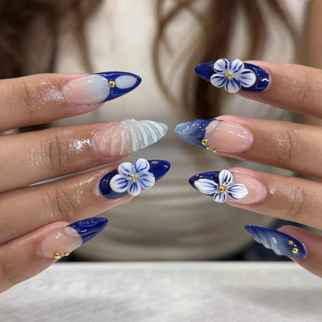 Artistic nail art with floral accents and glitter embellishments Bowlift