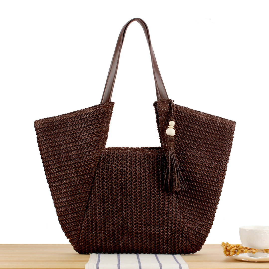 Beach bag made of natural weave with elegant leather accents Bowlift