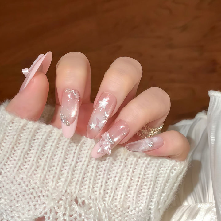 Artificial nail tips with glamorous glitter and bow details Bowlift