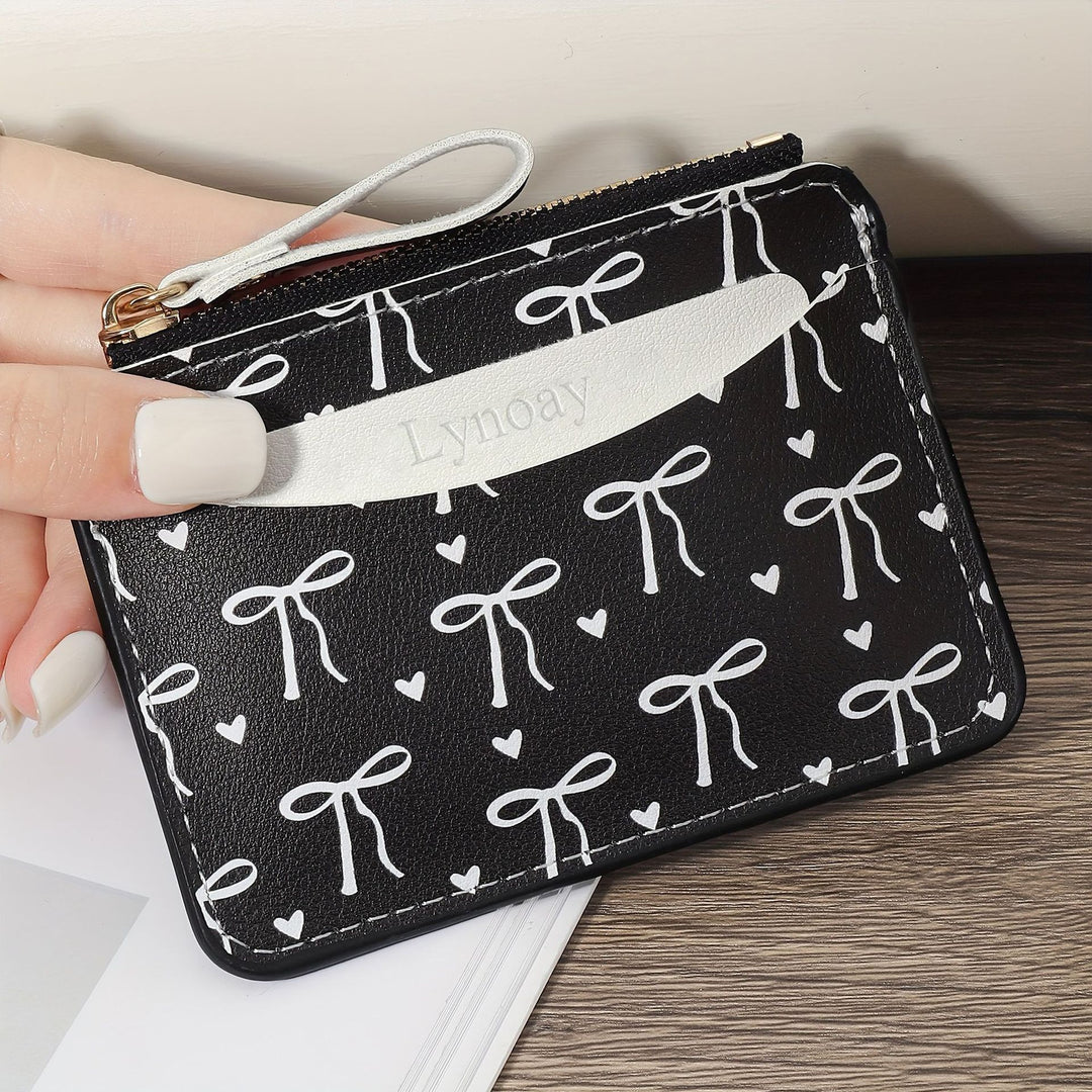 Compact bow-print coin purse wristlet with zipper closure Bowlift