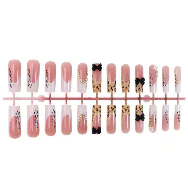 Artistic Press-On Nail Design with Bow and Animal Print Accents Bowlift