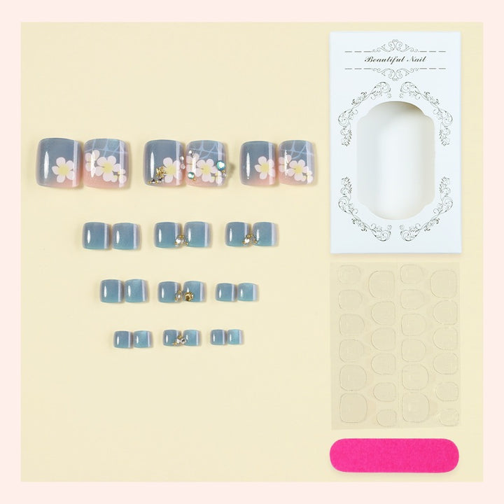 Artificial nail set with floral appliqués and glitter effects Bowlift