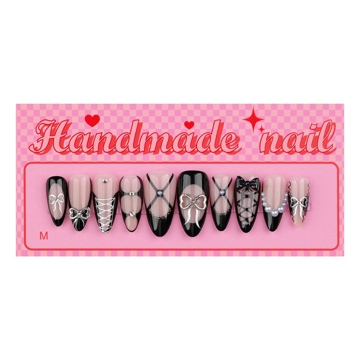 Artful nail art with elegant bows and glitter accents Bowlift
