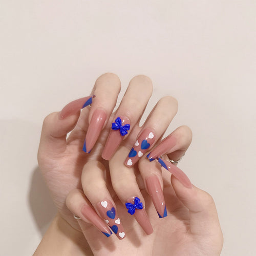 Artful stiletto nails with modern heart and bow motifs Bowlift