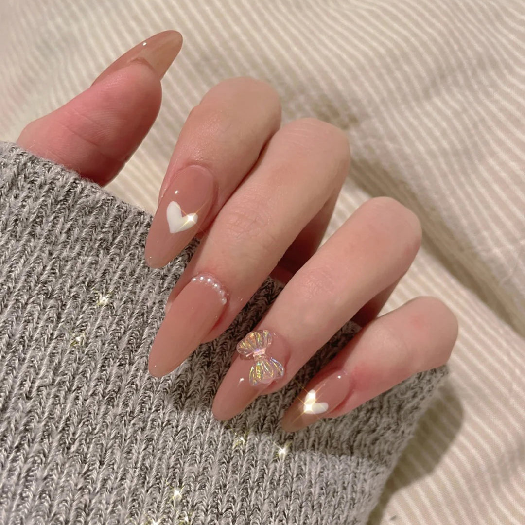 Elegant artificial nails with heart-shaped and glitter accents Bowlift