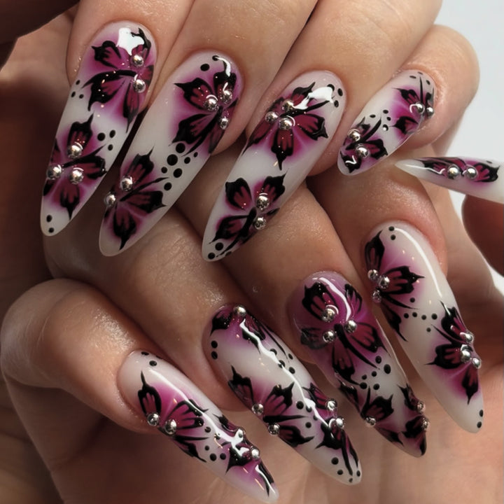 Artful nail art with floral design and rhinestone accents Bowlift