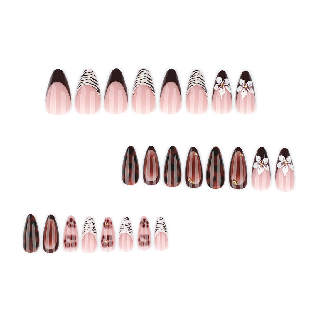 Artistic stiletto nails with elegant floral designs and glitter accents Bowlift