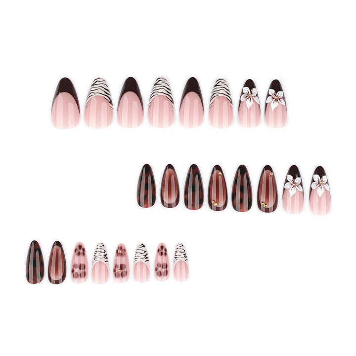 Artistic stiletto nails with elegant floral designs and glitter accents Bowlift