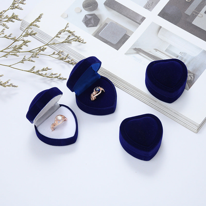 Heart-shaped velvet ring box with cushioned white interior and secure ring slot Bowlift