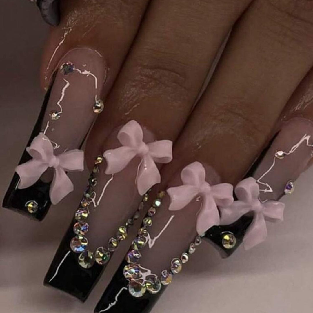 Artificial nails with elegant bows and rhinestone embellishments Bowlift