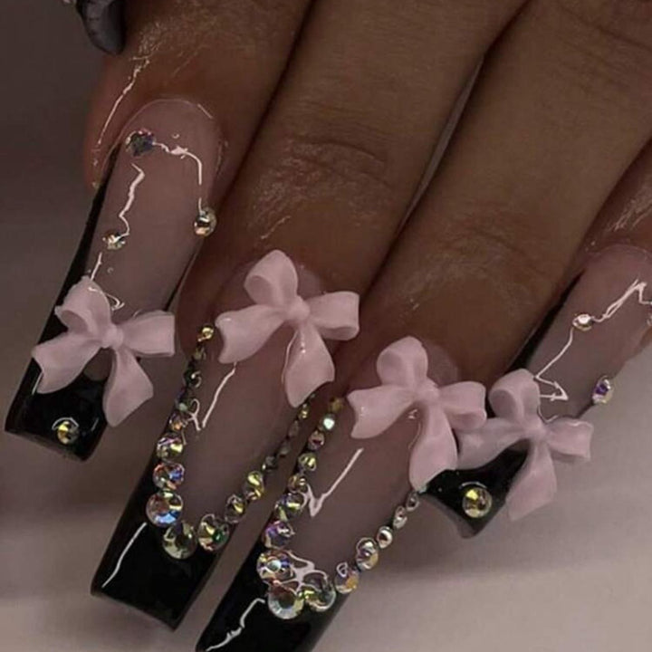 Artificial nails with elegant bows and rhinestone embellishments Bowlift