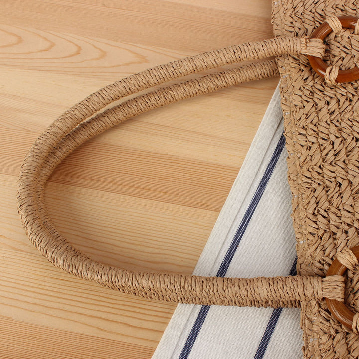 Beach bag made of natural woven material with sturdy carry handles Bowlift