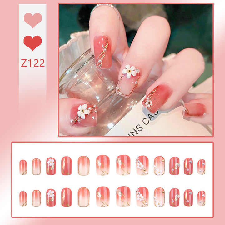 Acrylic nail set with elegant floral decorations and glamorous pearl accents Bowlift