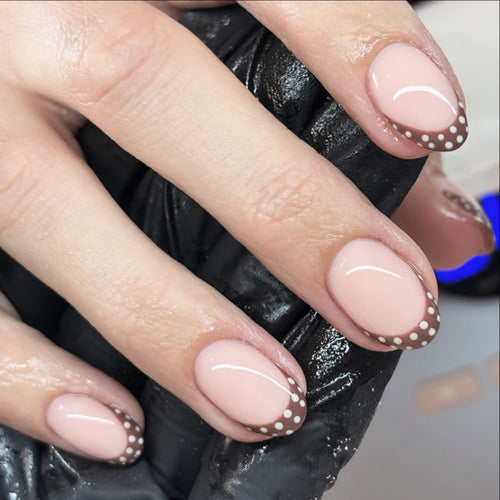 Artful nail design with elegant French tip and accents Bowlift