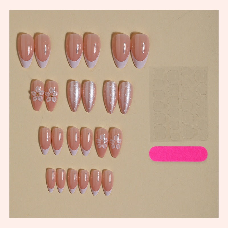 Artificial nail set with elegant French tips and delicate floral accents Bowlift