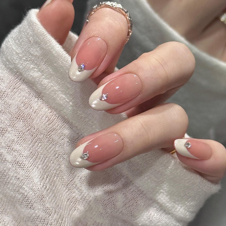 Artificial nails with elegant French style and sparkling accents Bowlift