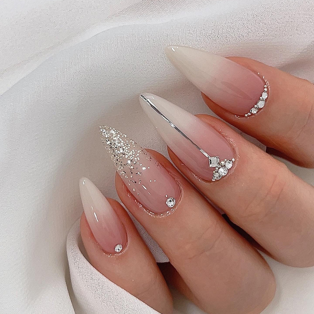 Glamorous stiletto nails with glitter and rhinestone accents Bowlift