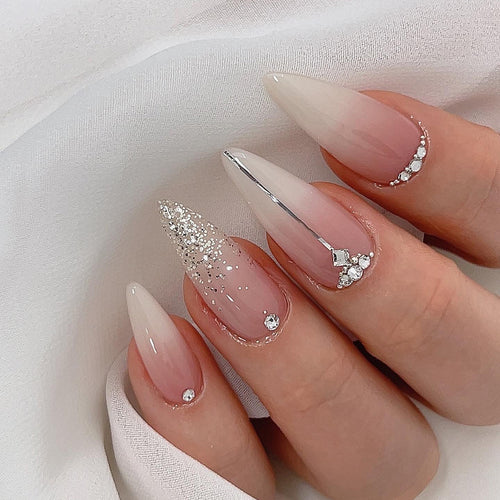 Glamorous stiletto nails with glitter and rhinestone accents Bowlift