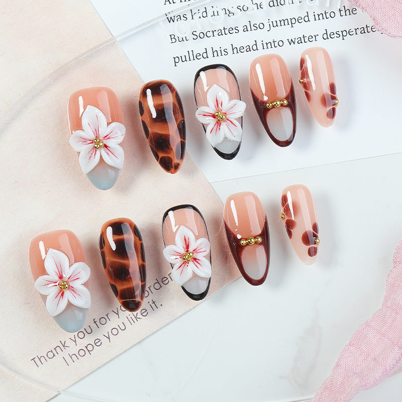 Acrylic nail set with floral accents and elegant embellishments Bowlift