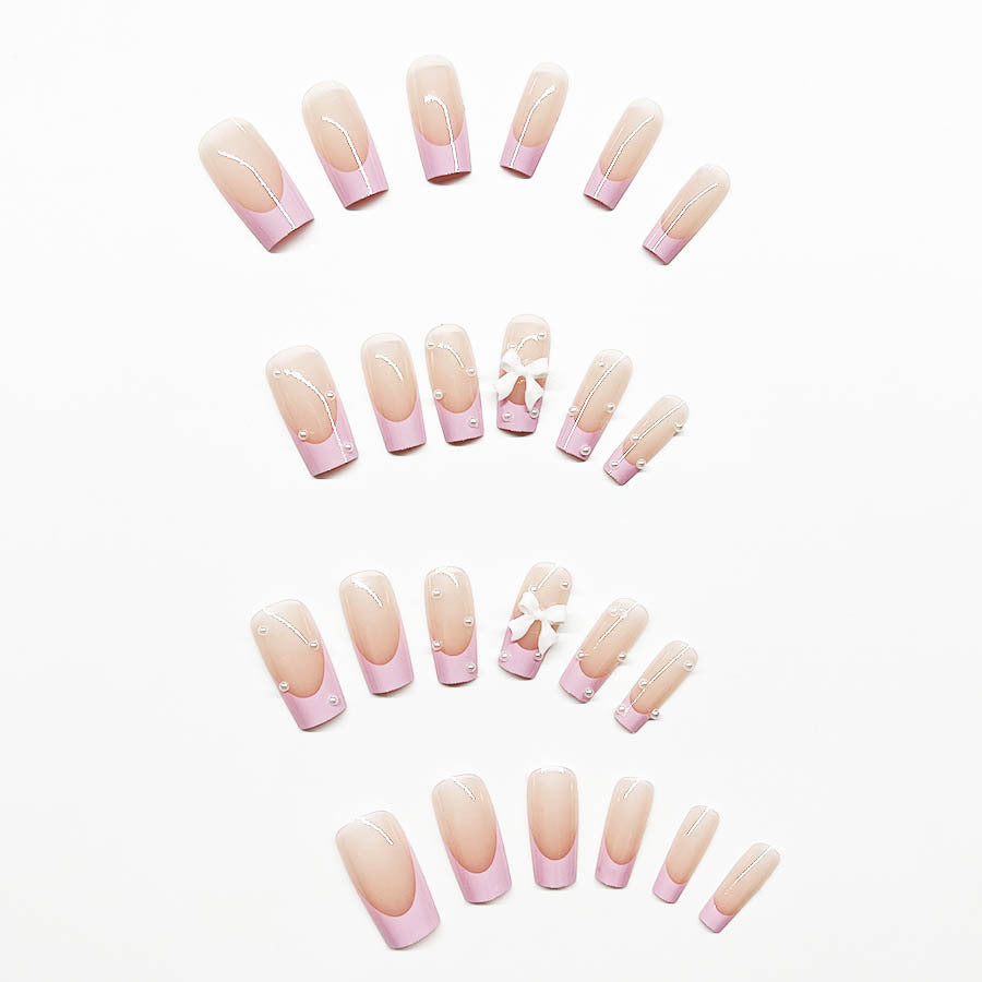 Artificial nail set with romantic bow and pearl embellishments Bowlift