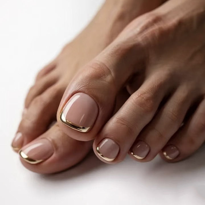 Artful toenail decoration with elegant gold accent Bowlift
