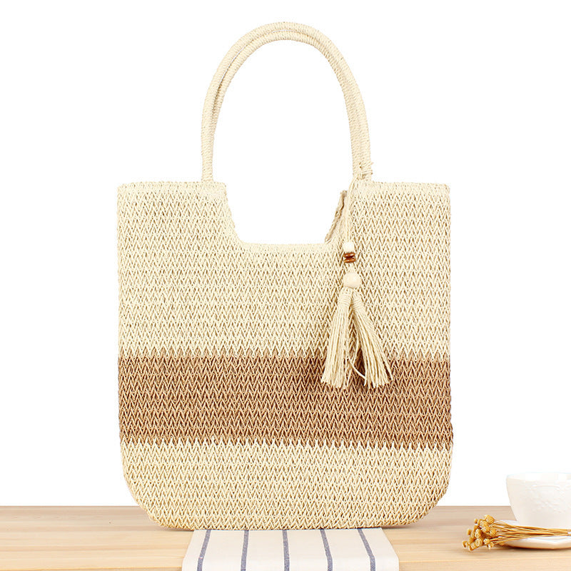 Fashionable beach tote bag made of woven natural material with fringed detail Bowlift