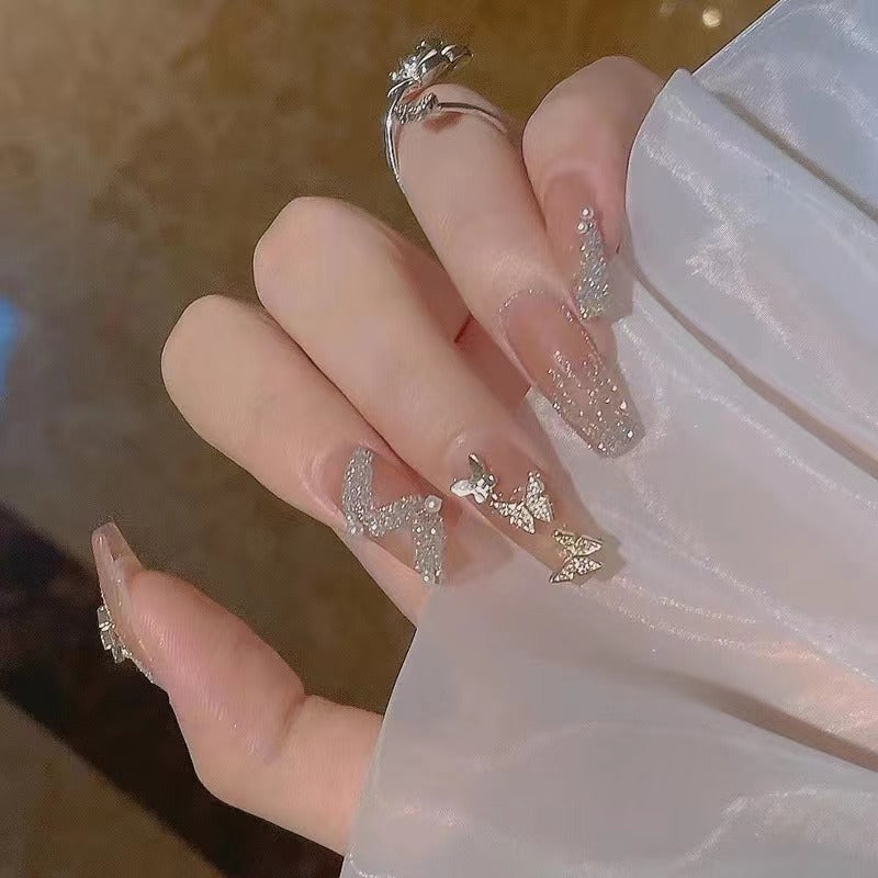 Glamorous nail art with rhinestone and butterfly elements Bowlift