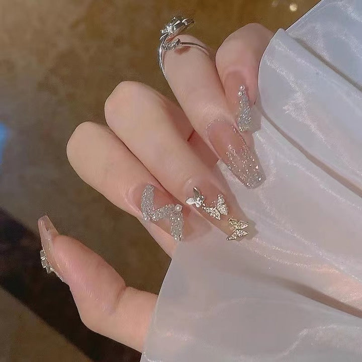 Glamorous nail art with rhinestone and butterfly elements Bowlift