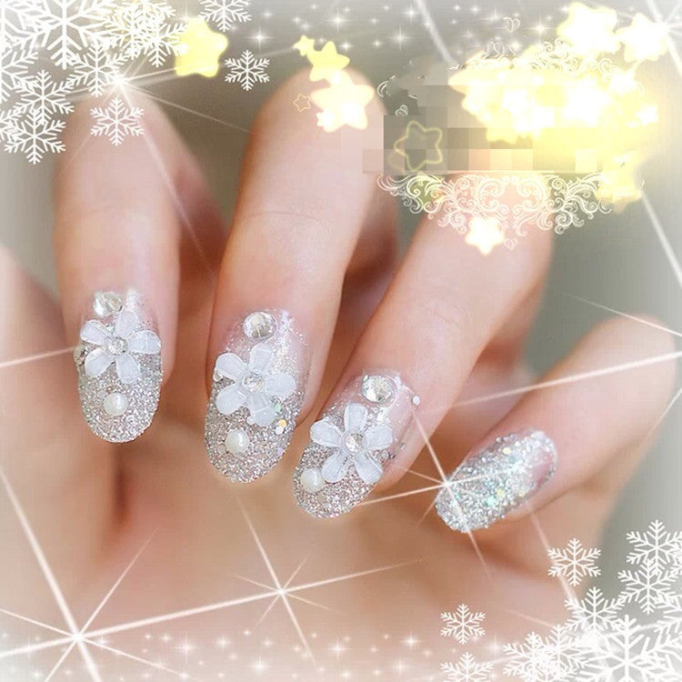 Artificials nails with sparkling rhinestone accents and elegant flower embellishments Bowlift