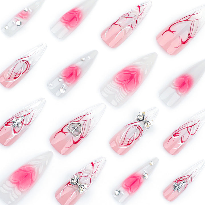 Artful stiletto nails with elegant floral accents and glitter embellishments Bowlift