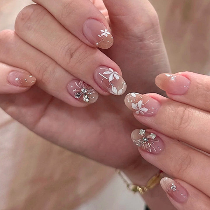 Artful nail design with floral pattern and glitter accents Bowlift