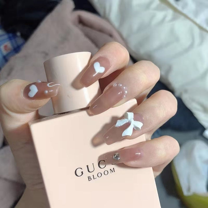 Artificial nails with heart and glitter accents Bowlift