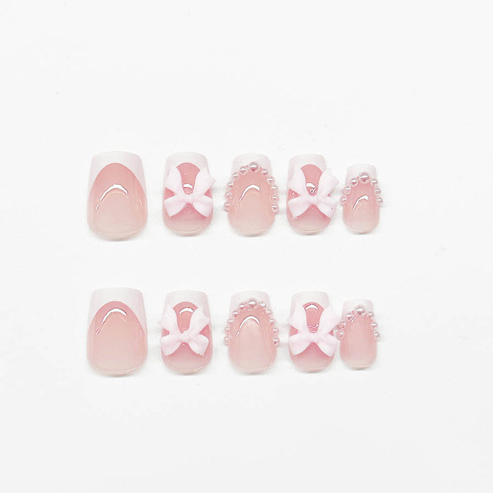 Artificial nails with elegant bows and pearl embellishments Bowlift