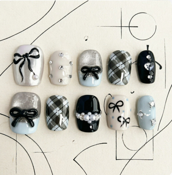 Artificial nails with elegant bows and rhinestones Bowlift