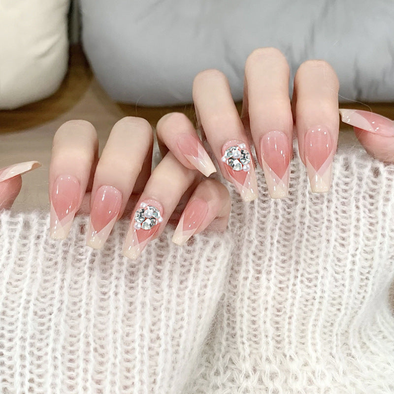 Artificial nail set with filigree tip designs and glamorous rhinestone accents Bowlift