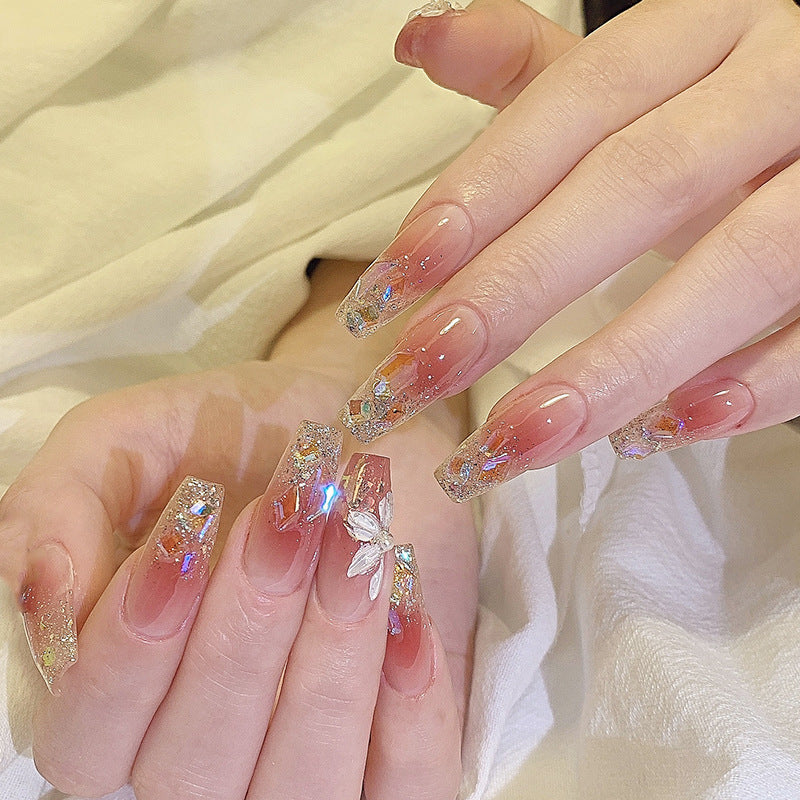 Artificial nail set with floral and glittering accents Bowlift