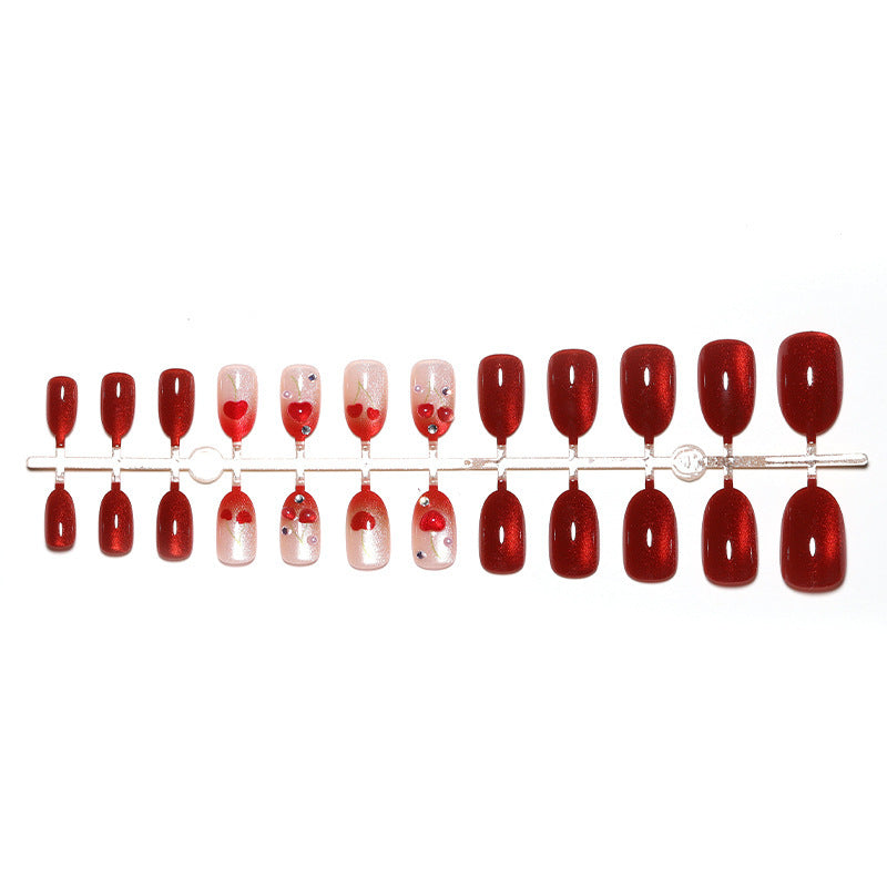 Artificial nail set with glamorous accents and creative heart motifs Bowlift