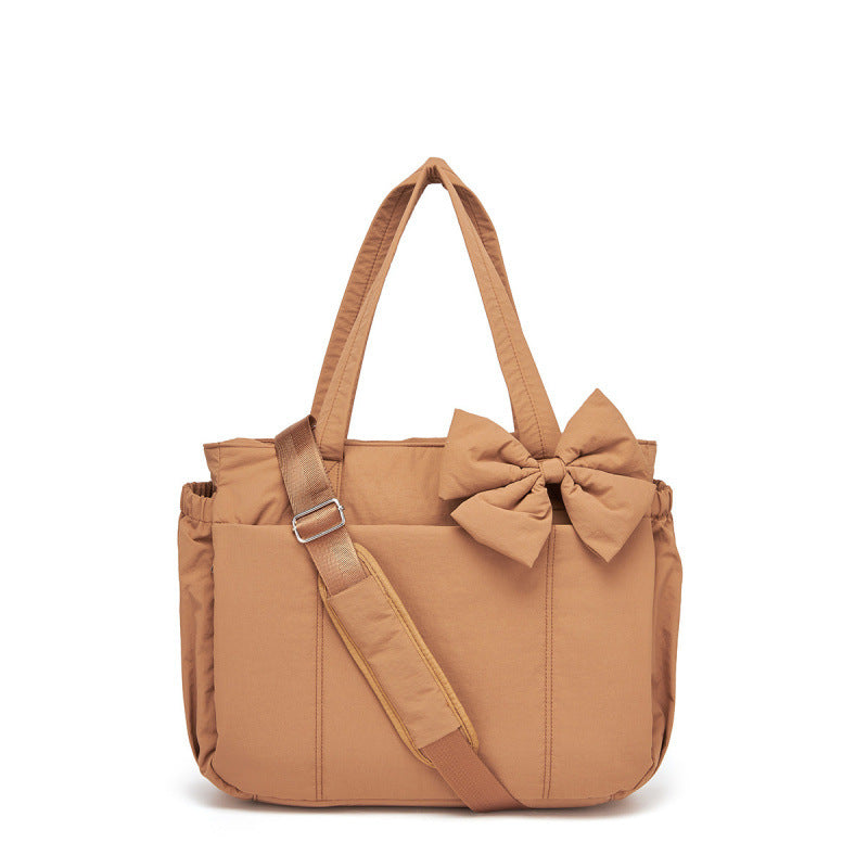 Fashionable tote bag with elegant bow appliqué Bowlift